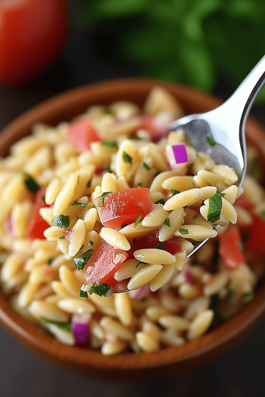 Bruschetta Orzo Pasta Salad slice on plate showing perfect texture and swirl pattern