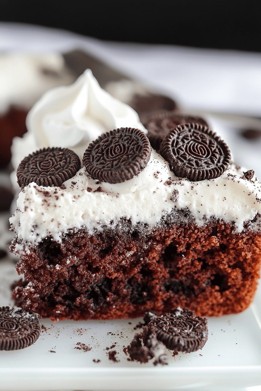 Oreo Poke Cake slice on plate showing perfect texture and swirl pattern
