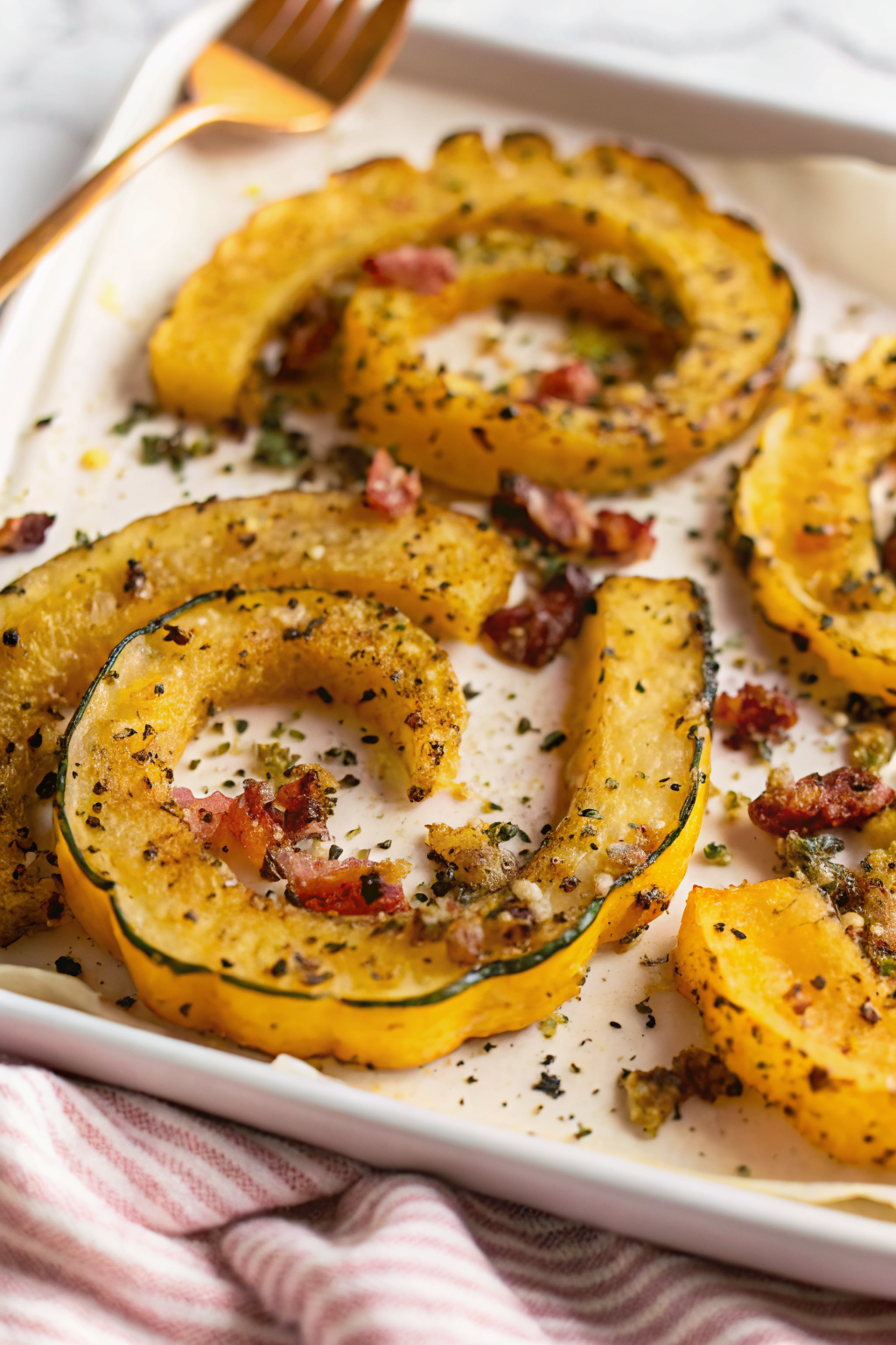 Parmesan Crusted Delicata Squash slice on plate showing perfect texture and swirl pattern