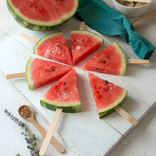 Frozen watermelon pops on wooden sticks