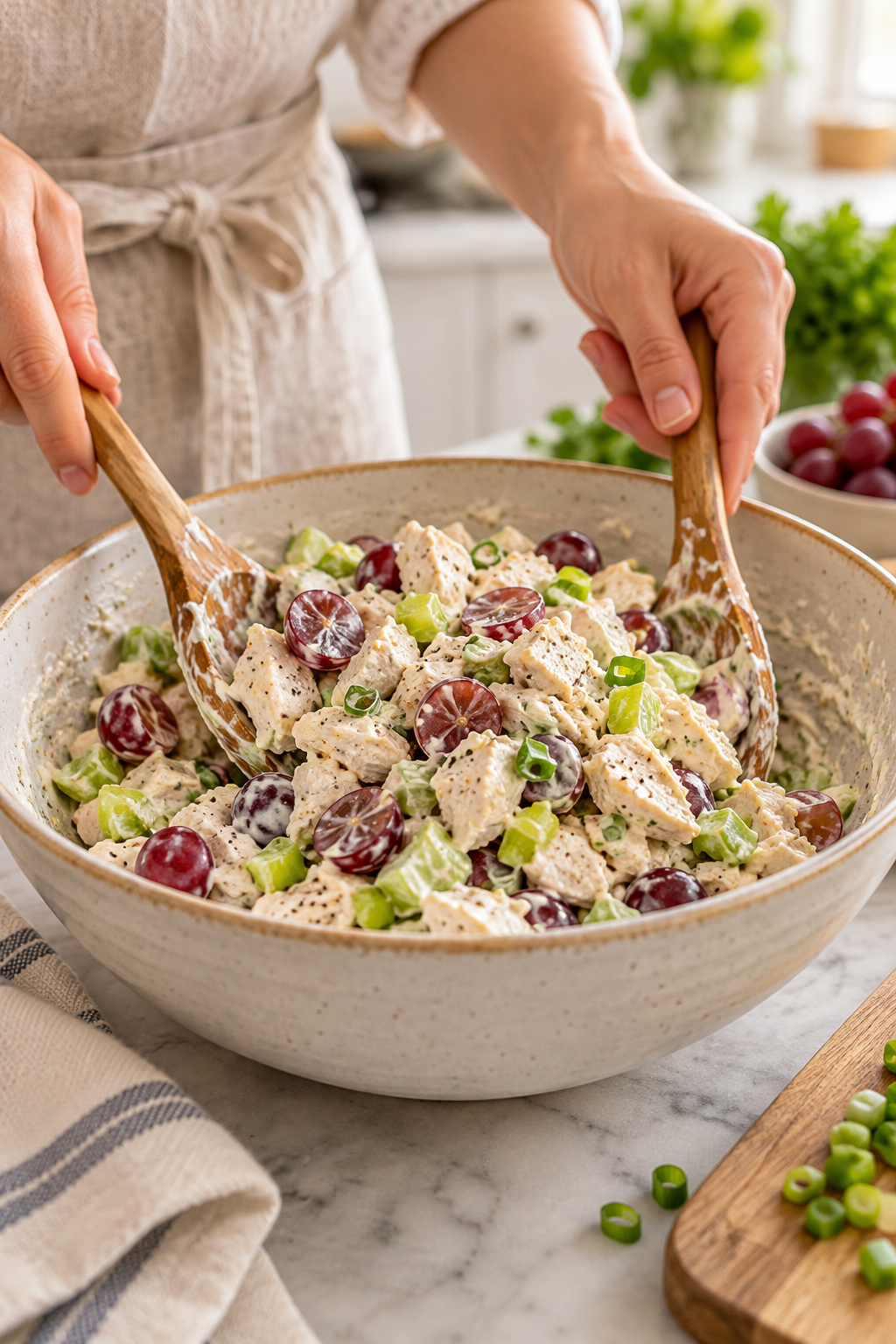 Mixing the creamy dressing into healthy chicken salad
